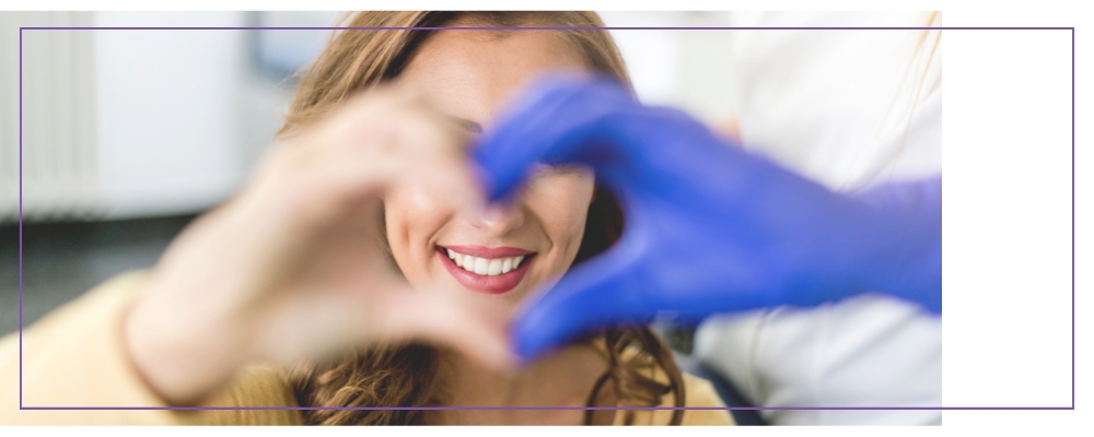 Dwie ręce jedna w rękawiczce tworzą serce w tle uśmiechnięta kobieta